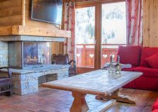 The lounge with log fire at Chalet Le Lievre